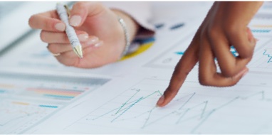 hand pointing to paperwork on desk